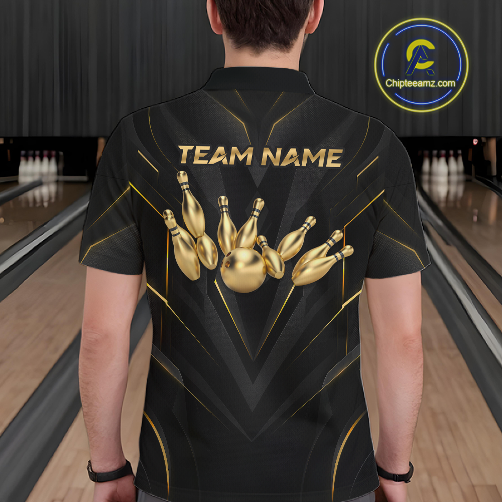 Person wearing a black bowling shirt with gold pins design and 'TEAM NAME' text in a bowling alley.