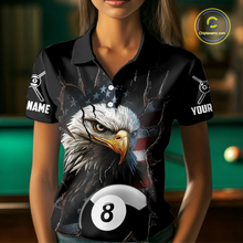 Load image into Gallery viewer, Woman wearing a black polo shirt with an eagle and pool ball design, holding a pool cue in a billiards setting.
