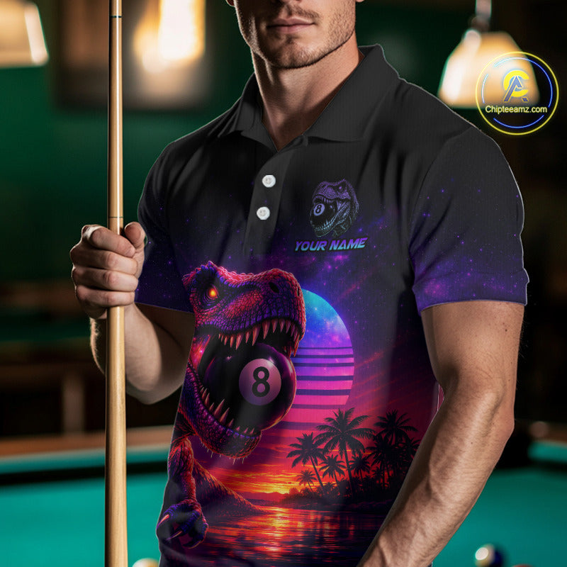 Man wearing a polo shirt with a dinosaur and sunset design, holding a pool cue in a billiards setting.