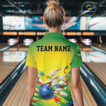 Female model at a bowling lane, back view of green and yellow polo shirt featuring autism puzzle bowling ball and pins graphics