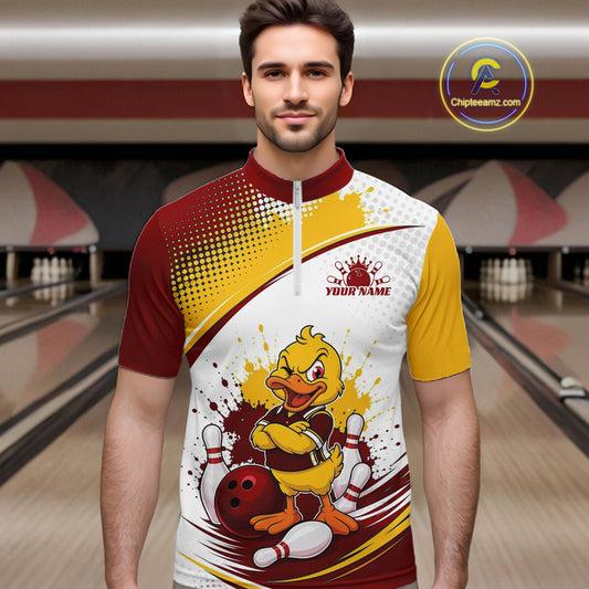 A man wearing a custom short-sleeve bowling jersey with a bowling-themed cartoon duck graphic, set against a blurred bowling alley background. The jersey features a white, yellow, and maroon design with a mock 'YOUR NAME' customization area.