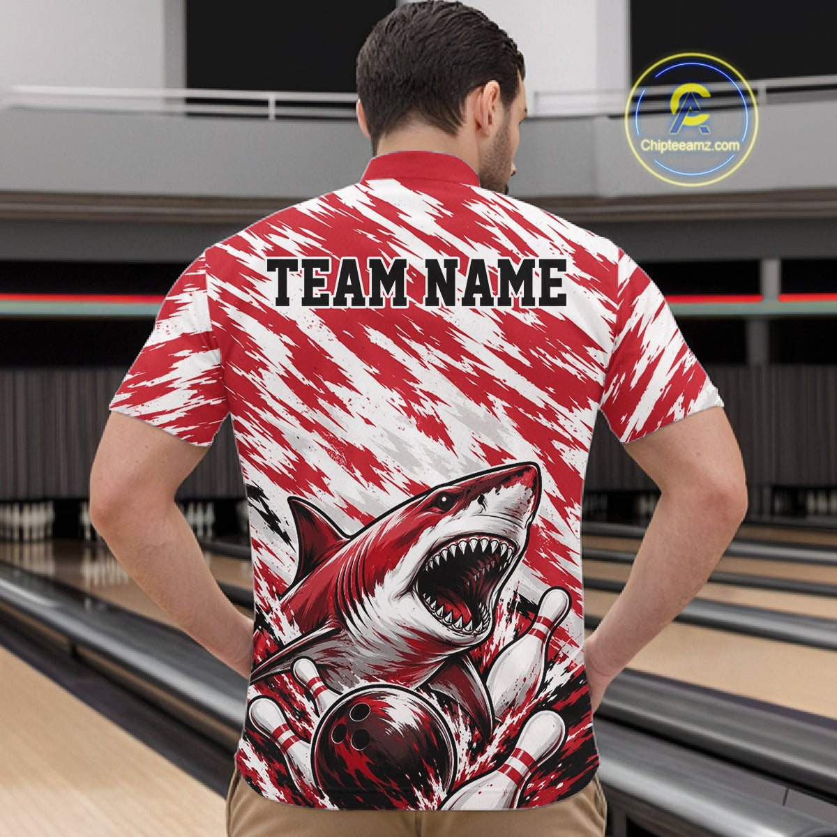 Person wearing a red and white sports jersey with a shark graphic and 'TEAM NAME' text on a bowling alley background.