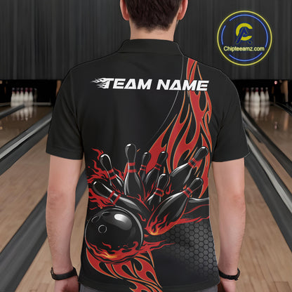 Back view of a male model in a bowling lane wearing a black polo shirt featuring red flaming black bowling ball striking pins with bold bowling visuals.