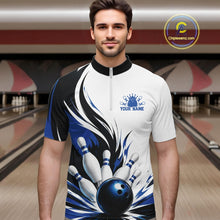 Load image into Gallery viewer, Male model wearing a white, black, and blue bowling quarter zip shirt with a flaming bowling ball knocking down pins graphic, shown from the front at a bowling lane.