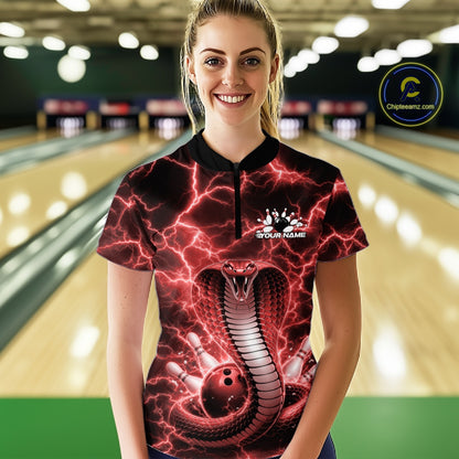 Female model wearing a bowling quarter-zip in a bowling center featuring red cobra artwork and lightning-themed graphics.