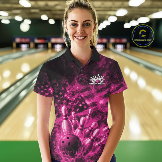 Female model at a bowling lane wearing a black and pink polo with patriotic bowling graphics and flame accents.