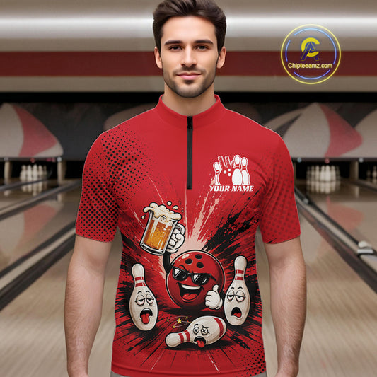 A man wearing a red short-sleeve quarter-zip bowling-themed graphic shirt with cartoon bowling pins, a bowling ball, and a beer mug, standing in front of a blurred bowling alley background.