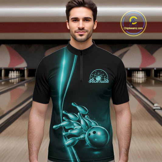 Front view of a male model in a bowling lane wearing a black quarter-zip shirt with turquoise blue bowling ball and pins design and sporty bowling visuals.
