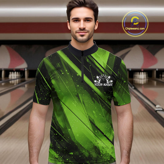 Man wearing a green and black bowling shirt with a personalized logo in a bowling alley.