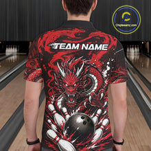 Load image into Gallery viewer, Person wearing a red and black dragon-themed bowling shirt with 'TEAM NAME' text in a bowling alley.