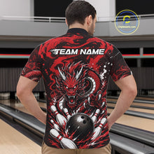 Load image into Gallery viewer, Person wearing a red and black dragon-themed bowling shirt with 'TEAM NAME' text at a bowling alley.