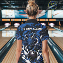 Load image into Gallery viewer, Person wearing a blue and black bowling shirt with a dragon design in a bowling alley.