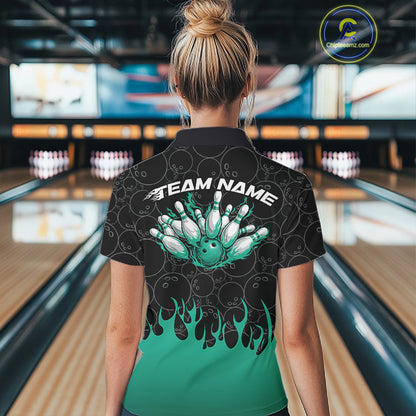 Back view of a female model in a bowling lane wearing a black polo shirt with bowling ball pattern and vibrant turquoise green flames rising in a bold sporty bowling design.