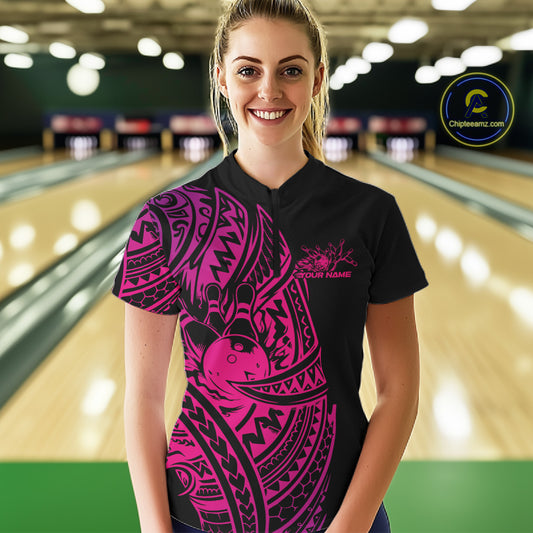 Female model wearing a black and pink bowling quarter-zip shirt at the bowling lane with bold Polynesian-inspired bowling artwork.