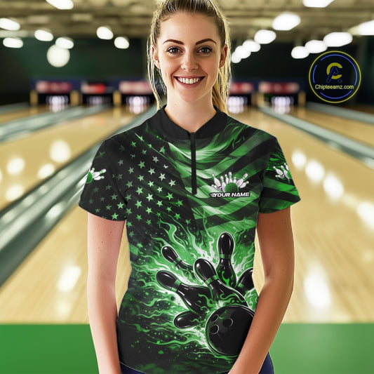 Female model wearing a black bowling quarter-zip shirt at the bowling lane with a green flame bowling ball striking pins and distressed American flag artwork.