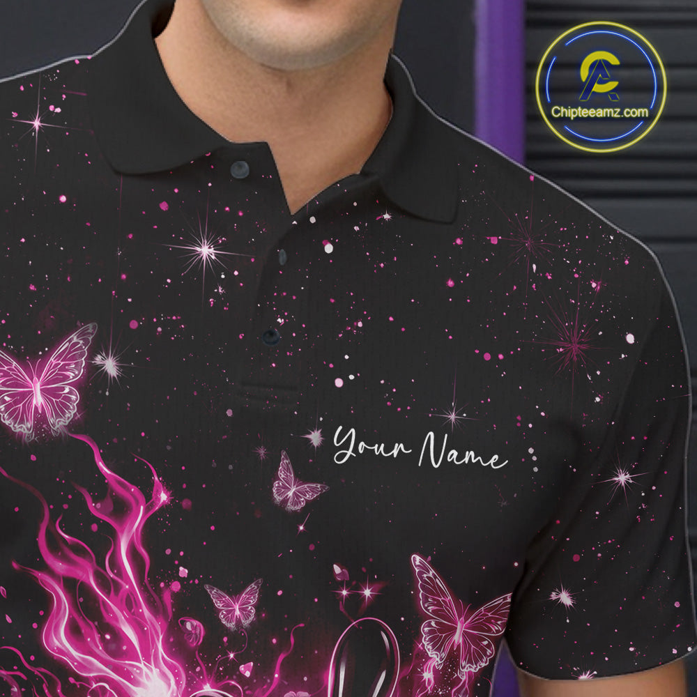 Left chest close-up of a black and pink bowling polo shirt with a flaming bowling ball, glowing butterflies, and cosmic accents.