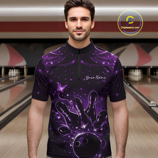 Male model wearing a black and purple bowling quarter-zip shirt at the lane with glowing butterfly bowling graphics.