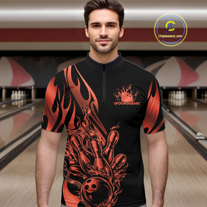 Male model front view in a bowling lane wearing a black quarter zip shirt with red gradient tribal flames and a bowling ball striking pins in action.