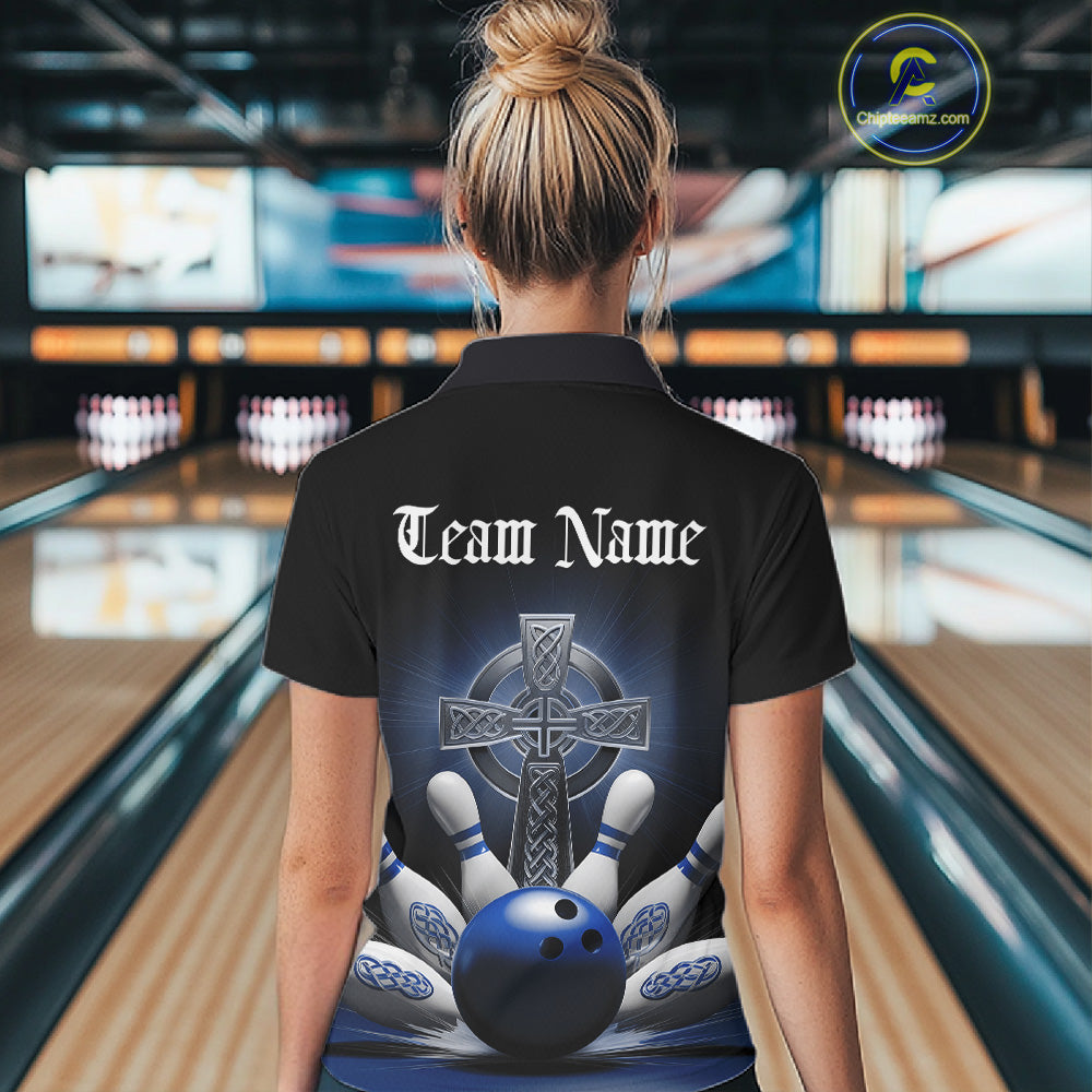 Back view female model at bowling alley wearing black polo shirt with blue Celtic cross and dynamic bowling strike graphic
