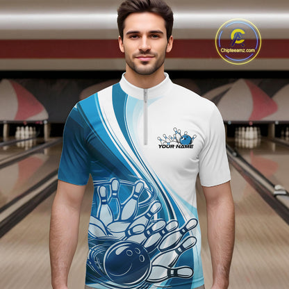 Male model in a bowling alley wearing a white and blue quarter zip shirt, showing a sweeping curve bowling ball striking pins design.