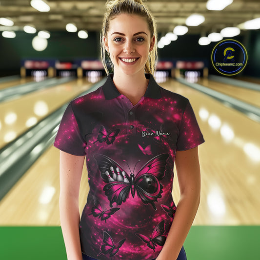Female model at a bowling lane wearing a bowling polo shirt with a pink and black butterfly artwork incorporating a bowling ball body.