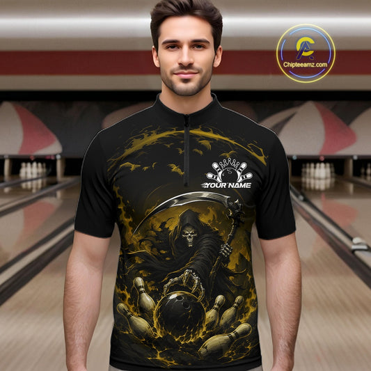 Front view of a male model wearing a black and yellow bowling quarter zip shirt featuring a grim reaper reaching through swirling flames to command a blazing bowling ball striking scattered pins in a bowling lane.