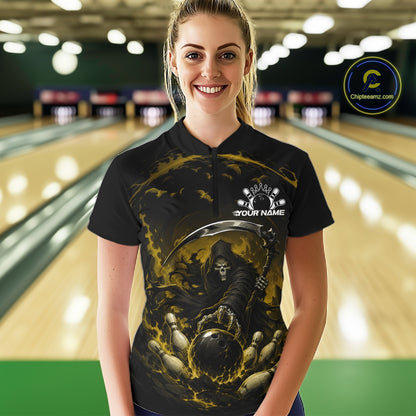 Front view of a female model wearing a black and yellow bowling quarter zip shirt showcasing a grim reaper with a blazing bowling ball striking scattered pins amid swirling flames in a bowling lane.