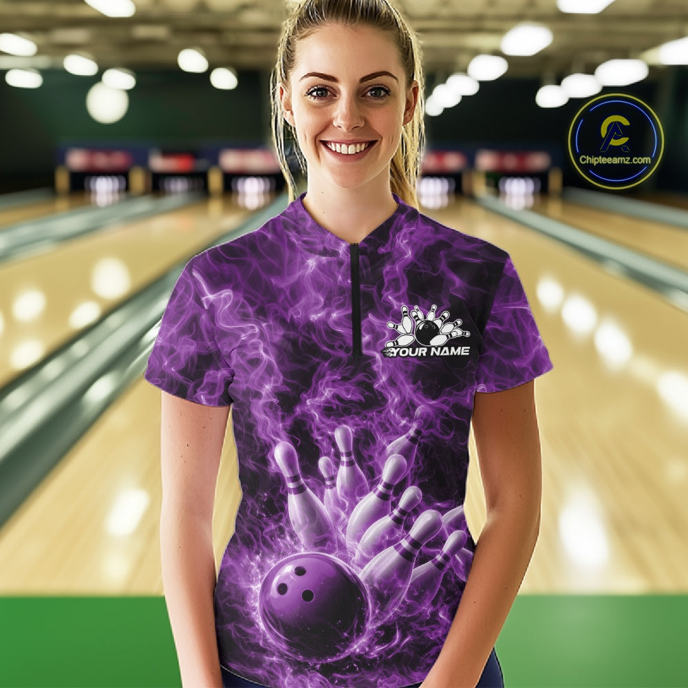 Female model at a bowling alley wearing a quarter-zip with a purple bowling ball, bowling pins, and fiery graphics.