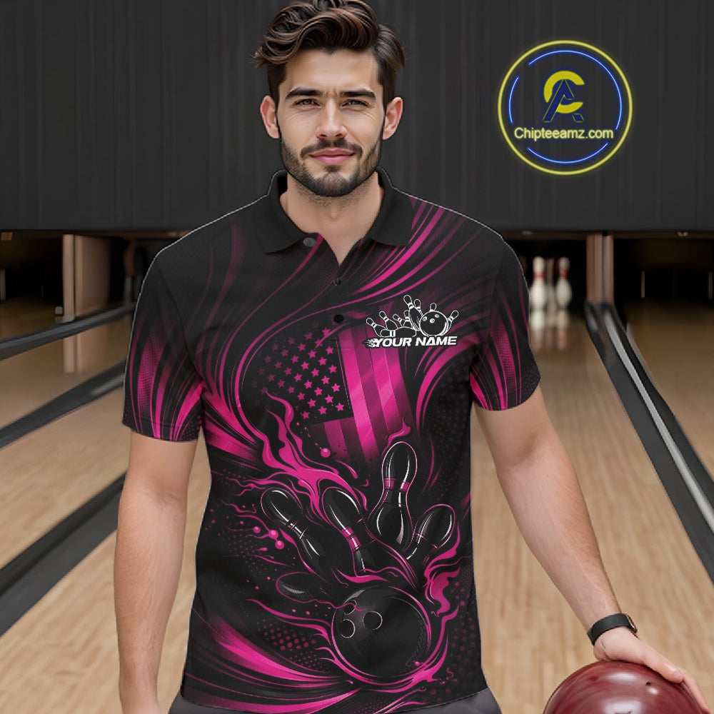 Male model at a bowling lane wearing a black and pink polo shirt with fiery bowling strike artwork and patriotic flag accents.