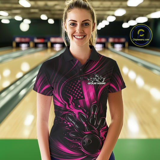 Female model wearing a black and pink bowling polo shirt at a bowling lane with patriotic bowling strike graphics and fiery details.