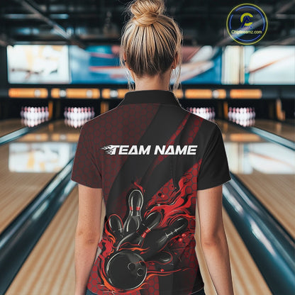 Female model at a bowling lane, back view of black and red quarter zip shirt featuring fiery bowling ball striking pins with hexagon and stripe design