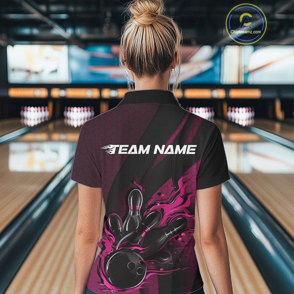 Back view of a female model in a bowling center wearing a black and pink polo shirt featuring a fiery bowling action scene.