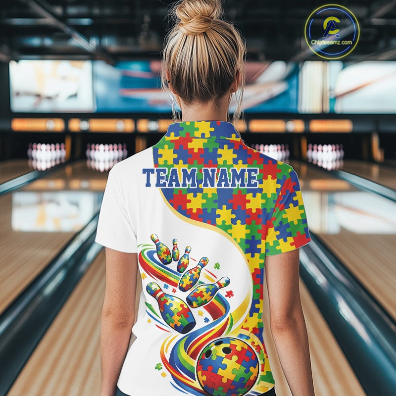Female model in a bowling alley, back view of white polo shirt featuring autism puzzle bowling strike artwork with vibrant colors