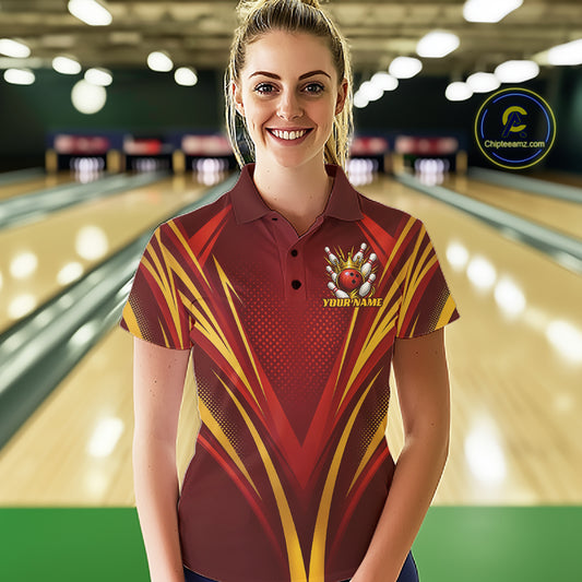 A woman stands in a bowling alley wearing a custom short-sleeve quarter zip shirt with a red and yellow geometric pattern and a bowling-themed crest on the chest. 