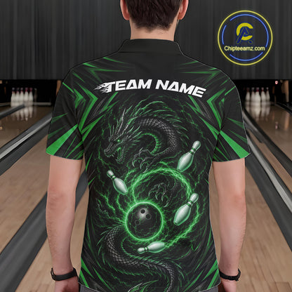A man viewed from behind wearing a black short-sleeve bowling polo shirt with a large green dragon and bowling pins graphic on the back, plus 'TEAM NAME' text across the shoulders. Bowling lanes are visible in the background