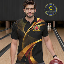 Load image into Gallery viewer, Man wearing a black bowling shirt with gold and red design in a bowling alley.
