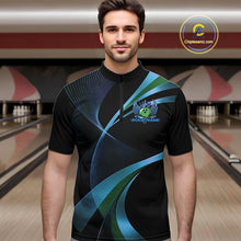 Load image into Gallery viewer, Man wearing a black bowling shirt with blue and green designs in a bowling alley.