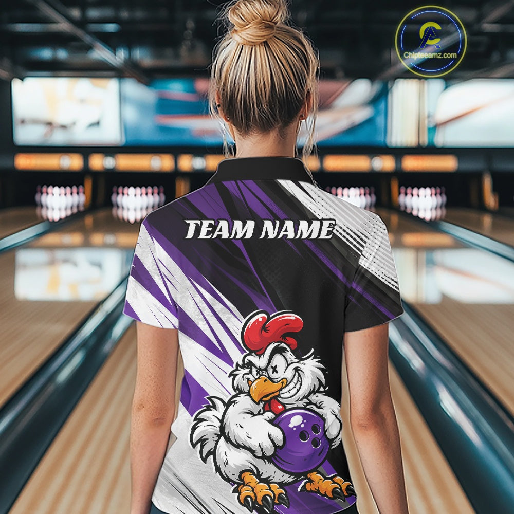 A woman viewed from behind wearing a custom bowling shirt in a bowling alley. The shirt features a black collar, purple and white graphic stripes, and a cartoon rooster holding a purple bowling ball.