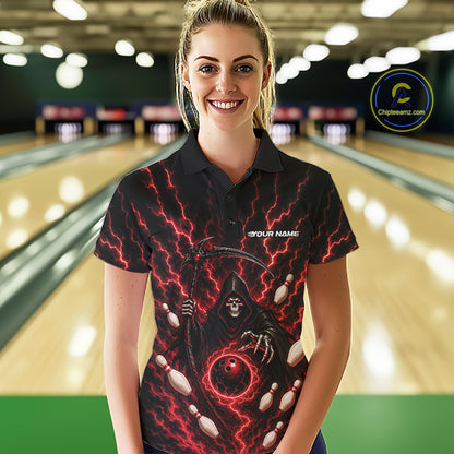 A woman stands in a bowling alley wearing a black short-sleeve polo shirt with a grim reaper graphic holding bowling pins and red lightning bolts. The shirt has a placeholder text 'YOUR NAME' on the chest.