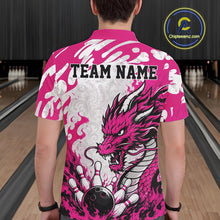 Load image into Gallery viewer, Person wearing a pink and white bowling shirt with a dragon design and 'TEAM NAME' text in a bowling alley.