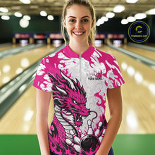 Load image into Gallery viewer, Person wearing a pink and white dragon-themed bowling shirt with a bowling ball graphic in a bowling alley.