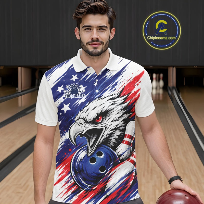 Man wearing a colorful polo shirt with an eagle and bowling ball design in a bowling alley.