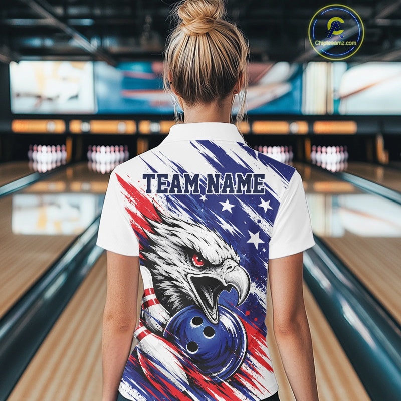 Person wearing a bowling shirt with an eagle design and 'TEAM NAME' text in a bowling alley.