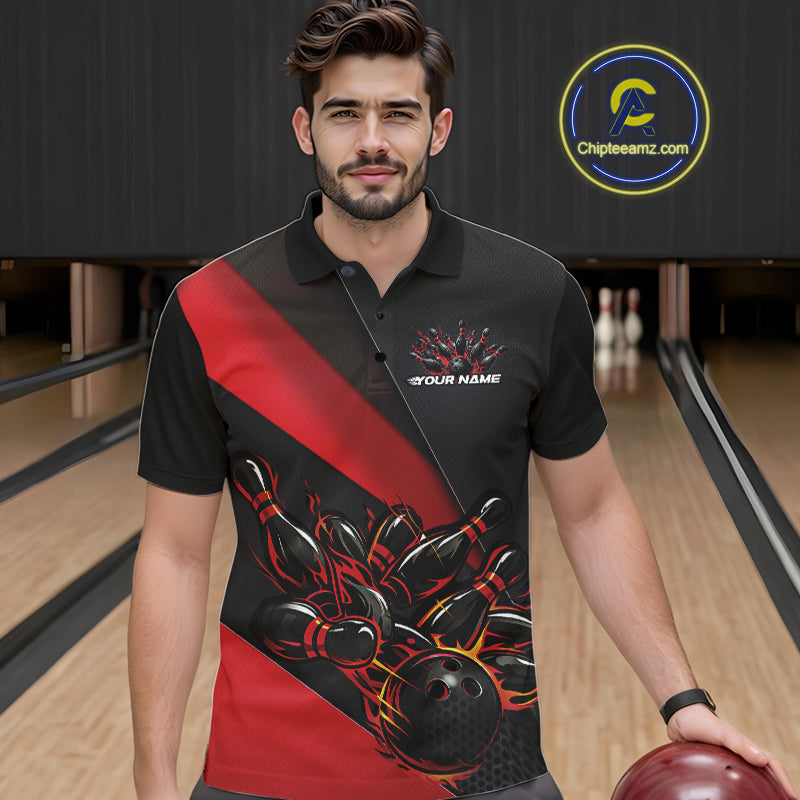 Male model seen from the front in a bowling lane wearing a black and red polo shirt featuring a flame bowling ball striking pins in a dynamic sports action scene.