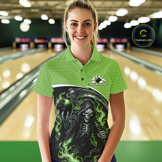 A woman stands in a bowling alley wearing a bright green short-sleeve polo shirt with a large black, gray, and green grim reaper graphic across the front. 