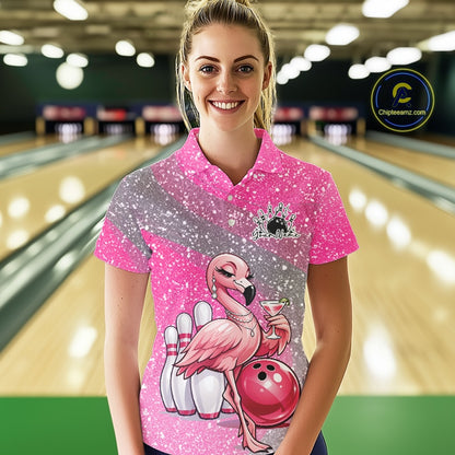 Female model at a bowling lane wearing a pink bowling polo shirt with an elegant flamingo, cocktail, and bowling ball design.