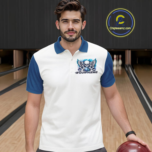 Front view of a male model in a bowling alley wearing a bowling polo shirt featuring a gothic skull with wings, bowling ball, pins, and ornamental swirls with a personalized name on a white and blue design.
