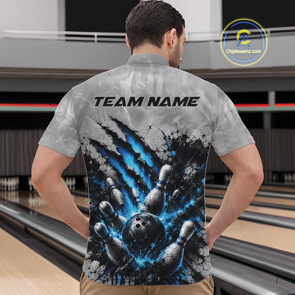 Front view of a male model wearing a gray bowling quarter zip shirt featuring a dramatic blue bowling ball and pins graphic with claw-mark artwork in a bowling lane.