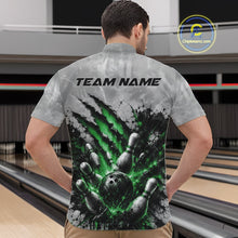 Load image into Gallery viewer, Front view of a male model wearing a gray bowling quarter zip shirt featuring a dramatic green bowling ball and pins graphic with claw-mark artwork in a bowling lane.
