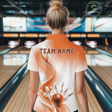 Load image into Gallery viewer, Female model standing in a bowling lane showing the back of a white and orange bowling quarter-zip shirt with abstract wave lines and a glossy bowling ball striking pins graphic.